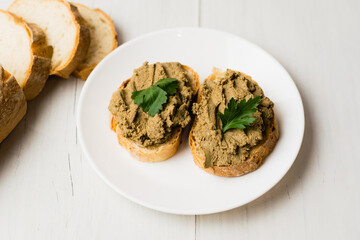 Healthy food, sandwiches with liver pate and a baguette with a crispy crust on a light background