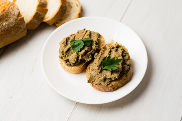 Healthy food, sandwiches with liver pate and a baguette with a crispy crust on a light background