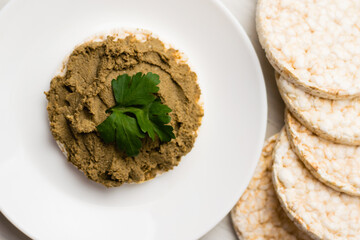 Healthy food, crispy rice cakes and beef liver pate on a light background