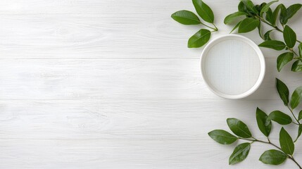 White bowl, water, green leaves, wood background, spa