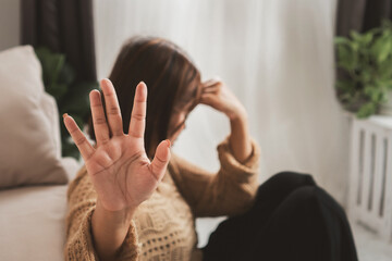Asian woman refusing treatment or medication for mental health disorder by gesturing with her hand