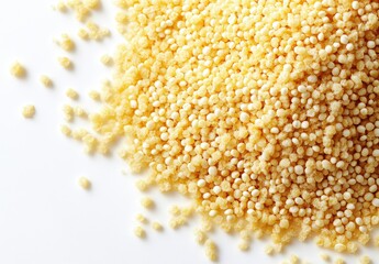 Close-up of fine yellow grains scattered on a white surface showcasing texture and depth with natural light creating bright highlights and soft shadows