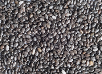 Detailed macro shot of small chia seeds with natural texture. A healthy superfood rich in fiber and omega-3, ideal for a healthy diet. top view, full frame