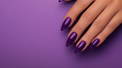 Elegant hand with purple nails against a rich purple background