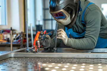 Welder joining metal parts using tungsten inert gas welding process