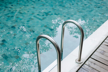 Pool with clear blue water and metal handrails