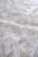 Fur coverlet and a fur decorative. Bedroom. Selective focus.