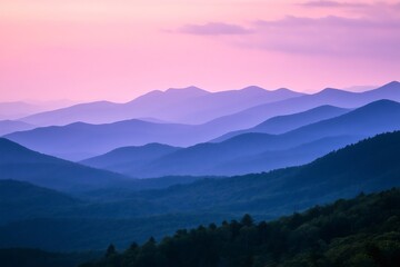 Fototapeta premium Layers of majestic mountains fading into the distance, enveloped by a serene pink and purple twilight sky at dusk
