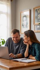 Group Sitting at Table with Laptop and Potted Plant