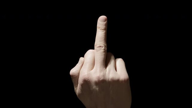 Hand showing middle finger on black background.
