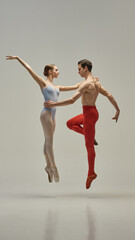 Ballet duo in graceful lift with extended lines and sculpted posture conveying weightless motion...