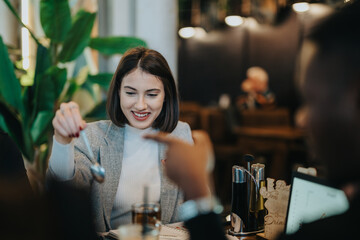 A close-up of a young woman enjoying time with friends at a cozy cafe, engaging in a lively and joyful conversation while sharing drinks. Warm and inviting atmosphere is present.