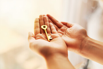  Two hands, one of which holds a golden key.