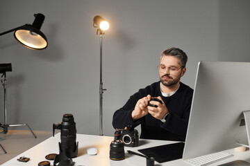 Creative professional capturing moments in a modern workspace filled with photography equipment