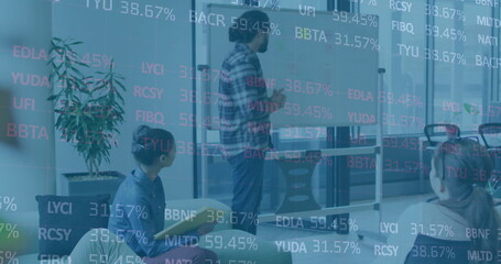 Image of stock market over diverse business people discussing work