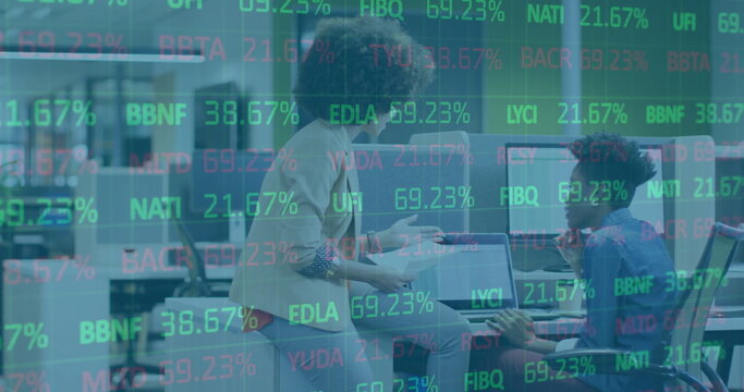 Image of stock market over diverse business people discussing work