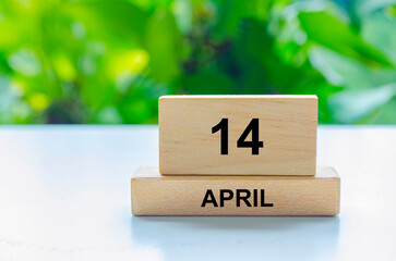 April 14 text on wooden blocks. Calendar concept with customizable space for text or messages