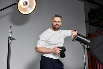 Creative professional capturing moments in a modern studio setting with his camera