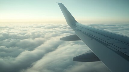Obraz premium The wing of an airplane gliding over a thick cloud cover, with distant continents visible below, symbolizing a flight over international boundaries.