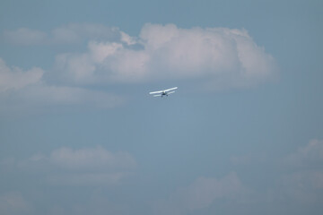 An-2 plane flying in blue sky with light clouds