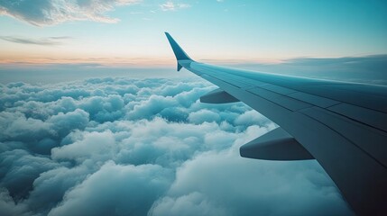 Obraz premium A wide shot of an international flight from the window perspective, showing a vast expanse of clouds beneath the airplane's wings.
