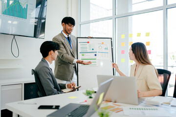 Man is giving a presentation to a group of people in a conference room