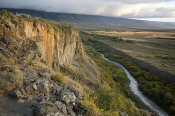 Obraz premium Autumnal Canyon River Landscape High Angle View of a Rocky Gorge with Winding River and Cloudy Sky