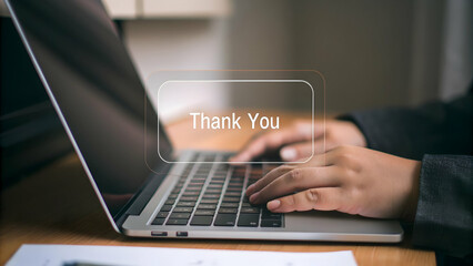 Glowing Thank You Message Hovering Above Laptop Screen: A Visual Concept for Expressing Gratitude in Digital Communications with Empty Space for Customization