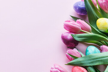 Easter flat lay. Stylish marble easter eggs and pink tulips on pink background with space for text. Easter modern banner mockup. Happy Easter