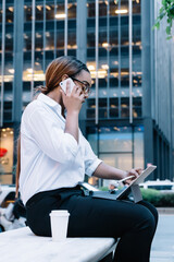 Fototapeta premium Focused businesswoman having phone call using gadgets in work