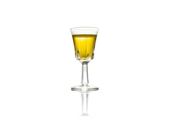 A shot of tequila on a isolated shot glass on white background.
