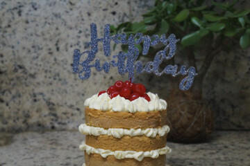  birthday cake with layers of sponge cake and cream filling decorated with poster