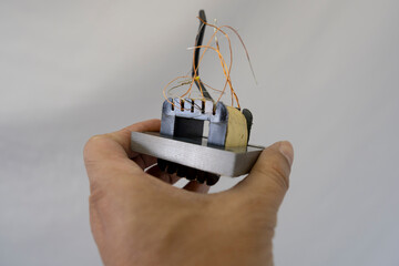 Disassembled Power Supply Transformer with Metal Parts and Wires