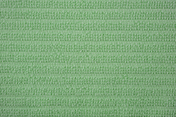 Textile close up of a green  fabric, fabric texture as a background.