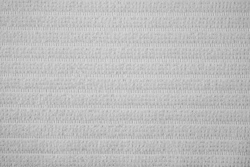 Textile close up of light grey fabric, fabric texture as a background.