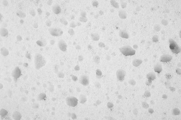 Close up of a light grey, sponge, sponge texture as a background.