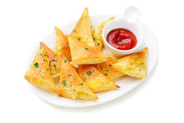 Vegetarian samsa (samosas) with tomato sauce and herbs. Stuffed with potato. isolated on white  background	