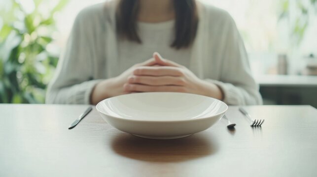 Abdominal pain from bloating, a person sitting at a table holding their stomach. Featuring discomfort and digestive care