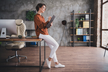 Full length photo of lovely young lady sit table sign contract dressed brown satin shirt startup...