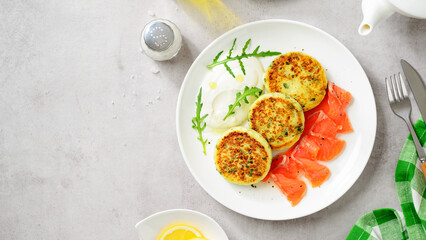 Salted cottage cheese pancake with greens, served with smoked salmon slices and sour cream. Healthy...