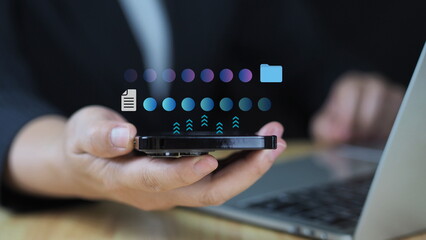 digital technology concept.Businessman using smartphone and laptop computer to transfer document...