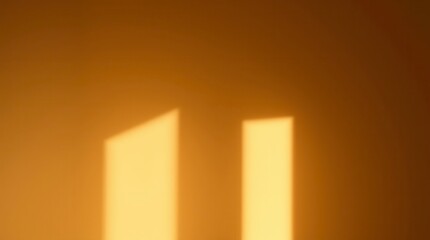 The warm glow of sunlight creates window light beams dancing on a solid ochre-colored wall.