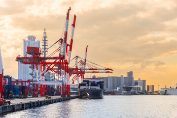 Obraz premium Container port and container crane at Industrial port for cargo container ship Osaka Japan. Business logistic transportation concept.