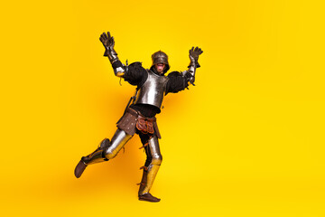Young Male in Medieval Armor Posing Against Vibrant Yellow Background