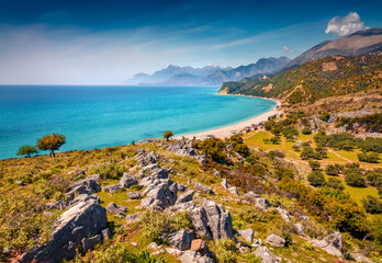 Aerial morning view of rocky hills near Lukove beach. Colorful summer seascape of Adriatic sea. Picturesque landscape of campsite in Adriatic coast of Albania. Beauty of nature concept background.