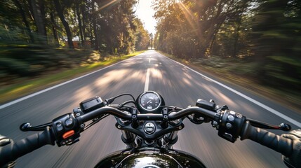 Naklejka premium Dynamic shot of a motorcycle on the road in the woods is suitable for motorcycle advertising, travel blogs and articles about traveling on a motorcycle.