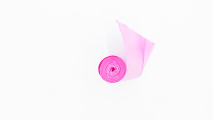 Roll of pink plastic garbage bags on white background, Pink color garbage bags roll,  Roll of pink plastic garbage bags on white background.
