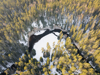 Drone view of the snowy Taevaskoda nature trail, highlighting Suur Taevaskoda sandstone cliffs in Estonia.