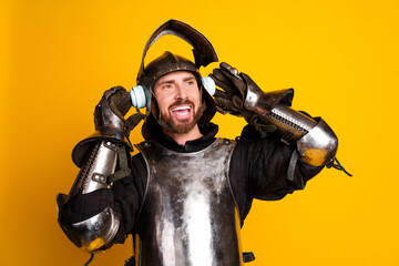 Happy knight in medieval armor with headphones against a vibrant yellow background