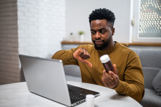 Displeased young African-American man expressing concerns about being given the wrong medication during a video consultation with his healthcare provider.